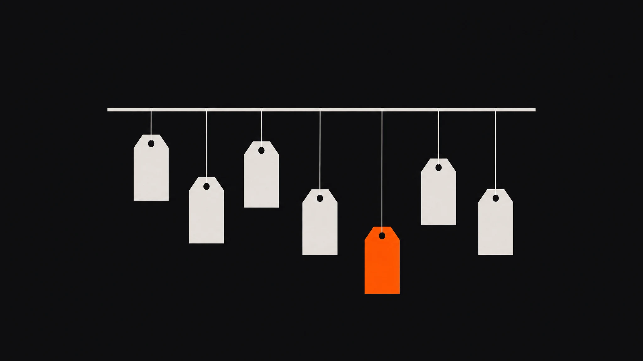 Seven blank price tags hanging on thin strings at different heights from a long ivory rod on a charcoal ground, six ivory and the lowest, just right of center, solid orange